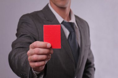 Businessman showing red card. Business and finance concept
