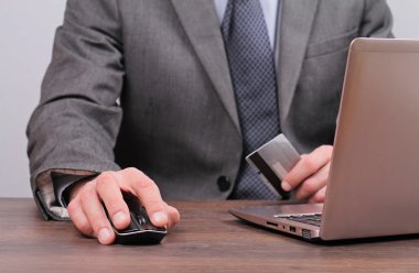 Businessman is using credit card for on line payment close up
