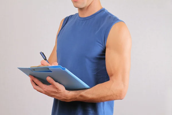 Personal fitness trainer with  workout plan close up. — Stock Photo, Image