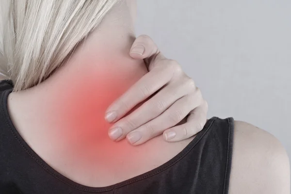 Woman with neck and back pain. Woman rubbing his painful back close up. Pain relief concept