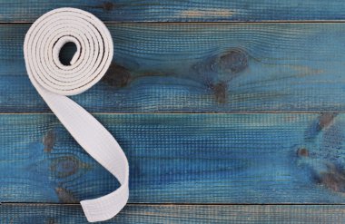 Material art background. Karate, Judo, TaeKwonDo belt on wooden table