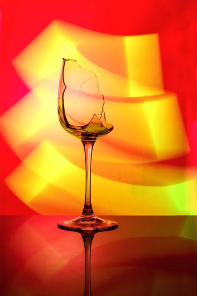 Art photo of a glass with multi-colored lighting — Stock Photo, Image