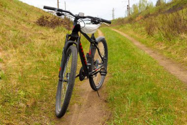 Bisiklet iki demiryolu arasındaki toprak yolda.