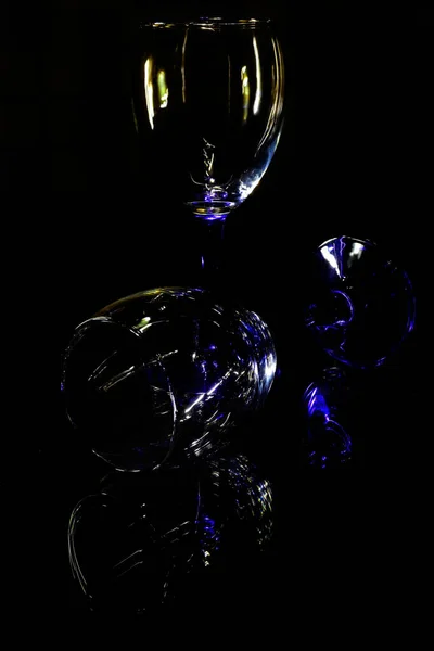 Crystal glasses on a glass table and their reflection — Stock Photo, Image