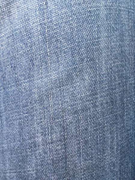 surface of dark navy blue denim jeans fabric for background.