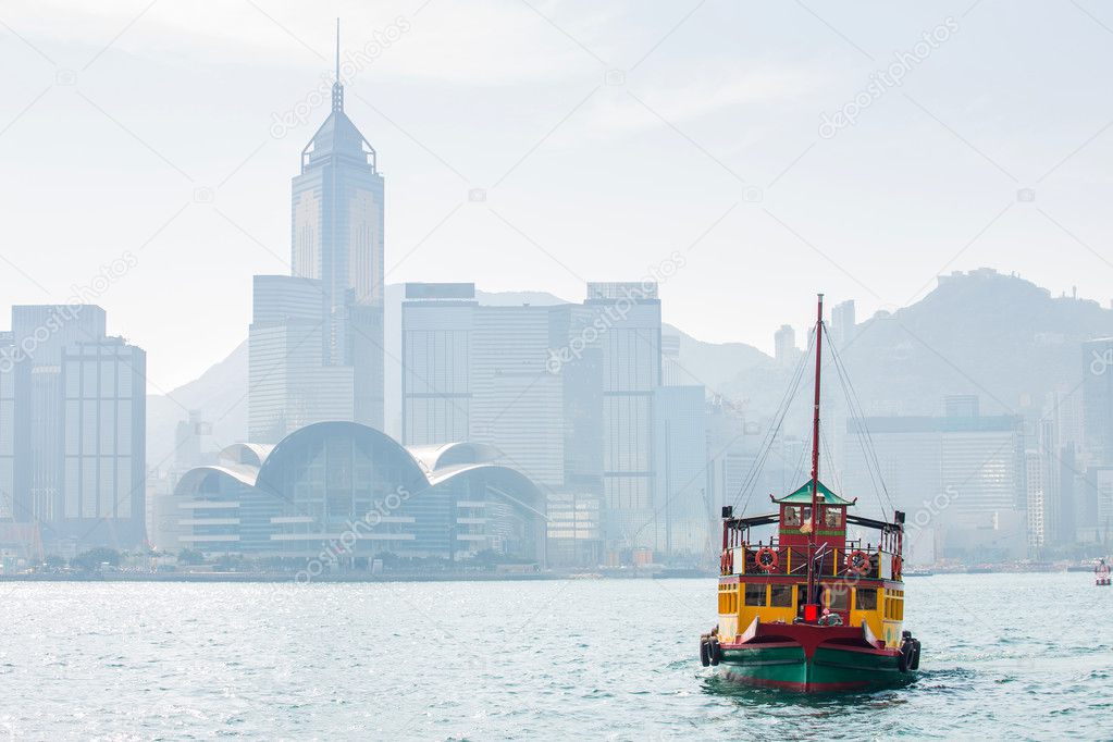 Hong Kong skyline with boats in Victoria Harbor.