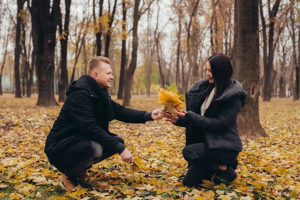 Νεαρό Ερωτευμένο Ζευγάρι Γελάει Και Συλλέγει Ένα Μπουκέτο Χρυσά Φύλλα — Φωτογραφία Αρχείου