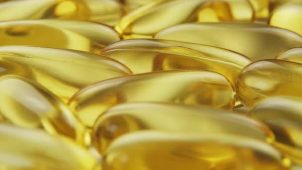 Super macro view omega 3 gold fish oil capsules, rotation background — Stock Video