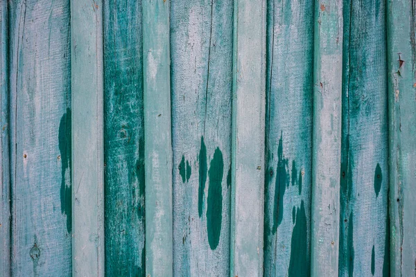 Texture, background, green fence of wooden planks, shabby paint and wet spots — Stock Photo, Image