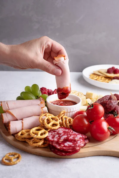 Plates Appetizer Female Hand Dipping Slice Ham Sauce Charcuterie Board Royalty Free Stock Photos