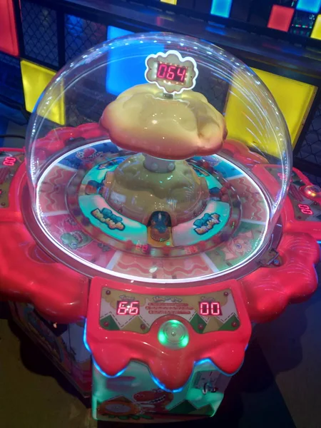 Gaming machine for small kids in the mall its also known as candy graber. Small balls rolling inside the machine.