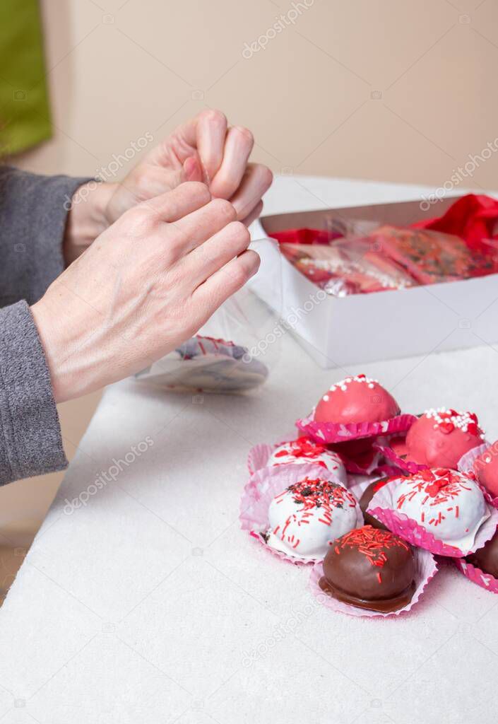 Woman hands handling Valentines chocolate