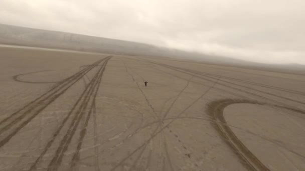 Tiro da fpv sport drone vincitore di successo maschio in piedi alzando le mani nel deserto di sabbia naturale — Video Stock