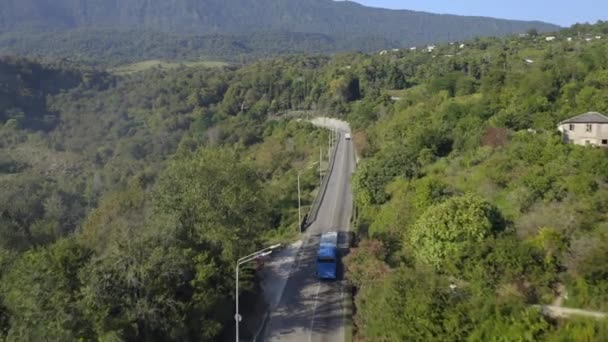 Aerial view passenger bus riding on asphalt high speed road beautiful green forest trees countryside — Stock Video