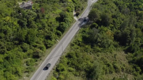 Automobile drives along asphalt road among forests to sea — Stock Video