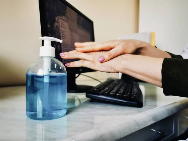 disinfection of hands with a sanitizer before and after working with a computer