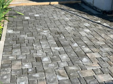 Construction or renovation of the sidewalk and road. Laying decorative road tiles.