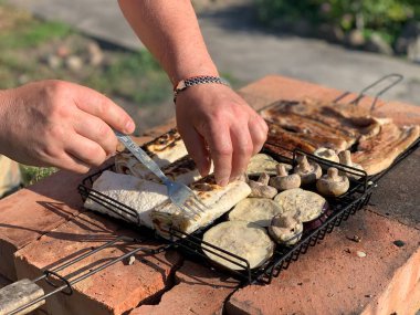 The process of grilling meat. Barbecue meat on the grill summer evening close up