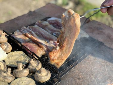 Steaks are fried on the grill top view.