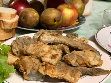 Fried fish in batter on a plate.