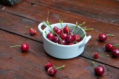 Grup lezzetli taze kırmızı kiraz ahşap arka plan üzerine aldı.