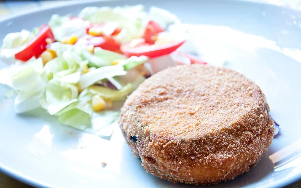 wrapped in breading and fried eggplant with tomato and lettuce