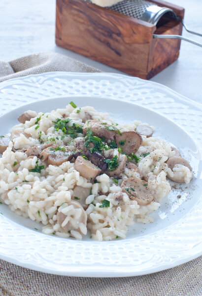 Pasta and rice with porcini mushrooms served with butter and parmesan form