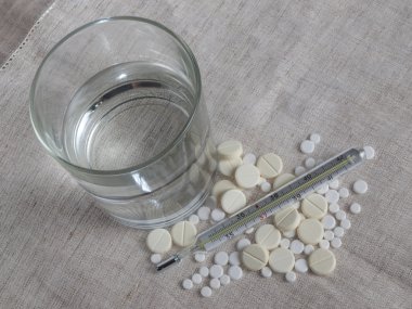 Su, termometre ve masa örtüsünü hapları