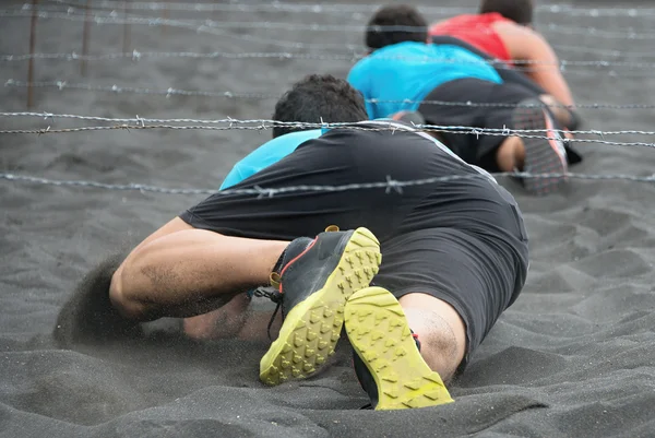 Crawling,passing under a barbed wire — Stock Photo, Image