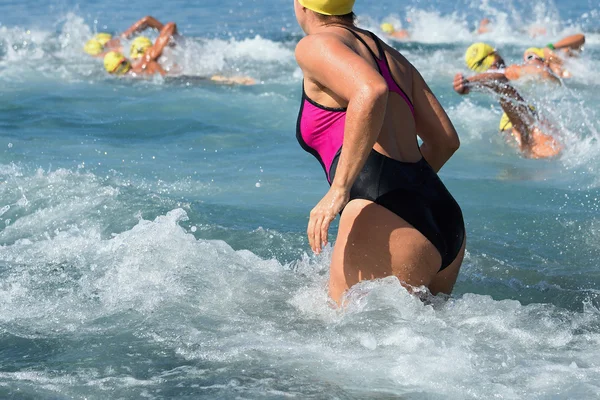 Mulher correndo na água na competição de natação — Fotografia de Stock