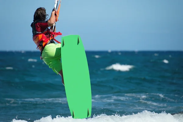 Kitesurfer flying over the wave — Stock Photo, Image