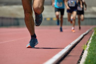 Atletizm ekibi sahada koşuyor.