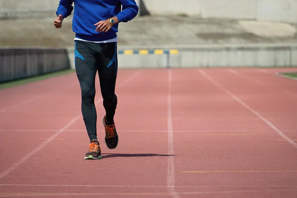 Athlete runner running on athletic track — Stock Photo, Image