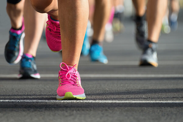 Marathon running race, runners feet on road