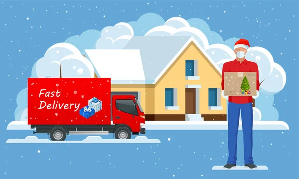Leverans lastbilar leverera julklapp och Courier i en ansiktsmask och en jul hatt med en låda i händerna i staden och snö faller. Levererar till hemmet. Gåvor i ljusa lådor. Vinterstad — Stock vektor