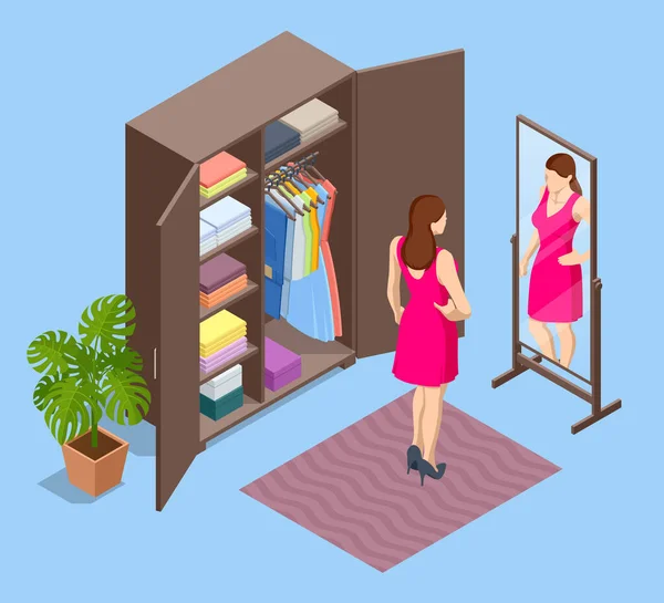 Isometric girl se tient près d'une armoire ouverte et choisit des vêtements. Femme essaie des vêtements et regarde dans le miroir — Image vectorielle