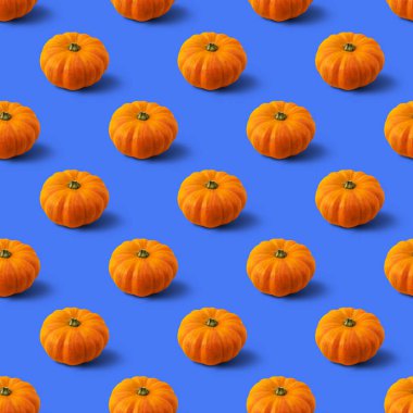 Mavi arka planda balkabağı desenli kusursuz desen. Sonbahar soyut arkaplanı. En az sebze konsepti.