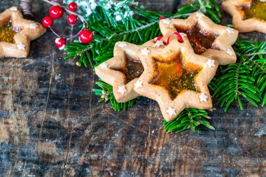Ahşap masa üzerinde bir yığın vitray pencere bisküvisi Noel ağacı süslemeleri. Yüksek açı görünümü