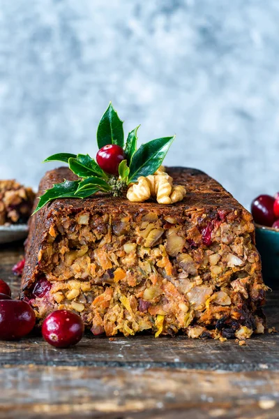 Vegan roasted nut loaf with cranberries on wooden table