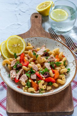Warm pasta salad with tuna, roasted red pepper and pine nuts clipart