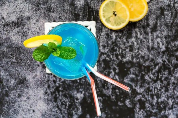 Blue Lagoon cocktail of blue curacao syrup mixed with vodka and lemonade