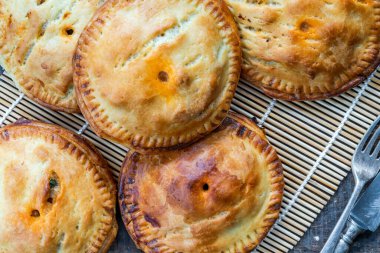 Chicken and chorizo pies in shortcrust pastry - overhead view clipart