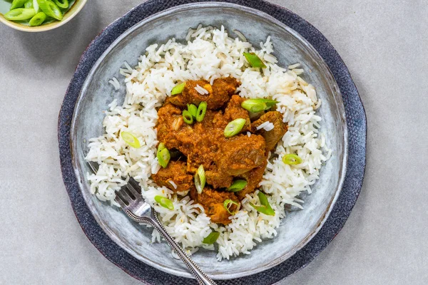 Tamarind duck curry with basmati rice - overhead view