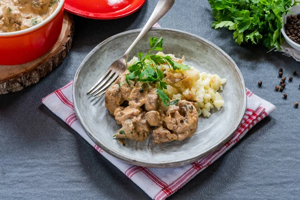 Beef goulash with creamy mushroom and black peppercorn sauce and crushed boiled potatoes