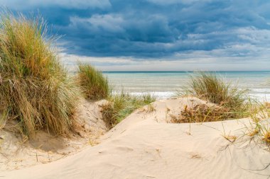Stormy clouds over the sea in Camber Sands beach in East Sussex, in the village of Camber, UK. clipart