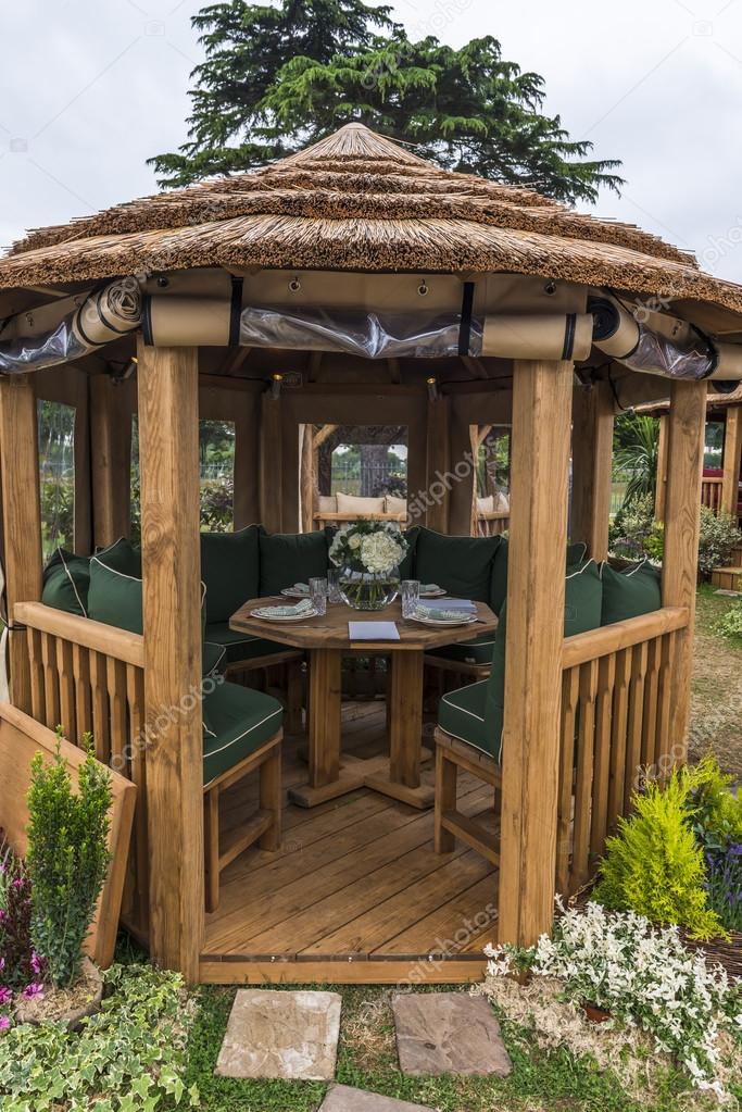 Gazebo with chairs and table set up in the garden