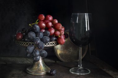 Kırmızı ve siyah üzüm ve bir kadeh kırmızı şarap