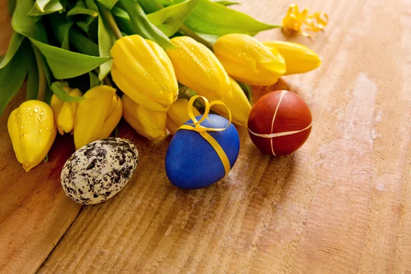 Colorful Easter eggs and tulips.