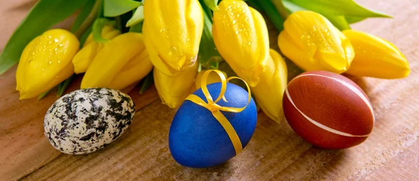 Colorful Easter eggs and tulips. — Stock Photo, Image