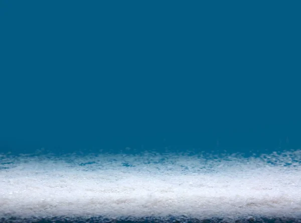 White snow isolated on blue Christmas background. — Φωτογραφία Αρχείου